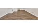 Spacious basement featuring wood-look floors and white trim at 4309 Birmingham Way, Raleigh, NC 27604