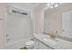 Bright bathroom with granite countertop, white vanity, tub and a window over the shower at 4309 Birmingham Way, Raleigh, NC 27604