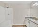Bright bathroom featuring a granite vanity and a shower with a white surround at 4309 Birmingham Way, Raleigh, NC 27604