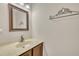 Cozy half bathroom featuring a vanity with marble top, framed mirror, and decorative towel rack at 4309 Birmingham Way, Raleigh, NC 27604