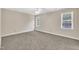 Bright bedroom with neutral walls, carpet flooring, ceiling fan, and large windows at 4309 Birmingham Way, Raleigh, NC 27604