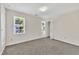 Bright bedroom featuring neutral walls, carpet flooring, and two windows at 4309 Birmingham Way, Raleigh, NC 27604