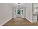 Sunlit dining room with bay window and elegant chandelier fixture, and hardwood floors at 4309 Birmingham Way, Raleigh, NC 27604