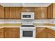 Oak kitchen with modern oven and built in microwave oven at 4309 Birmingham Way, Raleigh, NC 27604