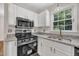 Modern kitchen with stainless steel appliances, granite countertops, and ample cabinet space at 4309 Birmingham Way, Raleigh, NC 27604
