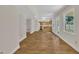 Open living room with kitchen view, wood floors, and natural light at 4309 Birmingham Way, Raleigh, NC 27604