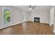 Inviting living room with wood-look floors, a cozy fireplace, and large windows overlooking the yard at 4309 Birmingham Way, Raleigh, NC 27604