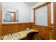 Small bathroom with wallpaper, a sink and a view of the backyard at 452 N Main St, Wendell, NC 27591