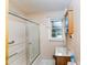 Bathroom featuring a shower with sliding glass door and window at 452 N Main St, Wendell, NC 27591