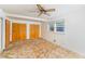 Bedroom with ceiling fan, double closets, and a window offering natural light at 452 N Main St, Wendell, NC 27591