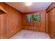 Bedroom featuring wood paneling, neutral carpet and view of backyard at 452 N Main St, Wendell, NC 27591
