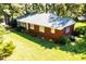 Charming brick home with a well-manicured lawn and mature trees providing ample shade at 452 N Main St, Wendell, NC 27591