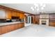 Open-concept living room with fireplace, chandelier, and seamless transition to the kitchen at 452 N Main St, Wendell, NC 27591