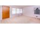 Bright living room with natural light, neutral carpet, and a classic front door at 452 N Main St, Wendell, NC 27591
