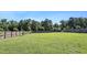 Large, green backyard with a wooden privacy fence at 46 Bellini Dr, Angier, NC 27501