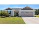 Charming single-story home with a well-manicured lawn and an attached two-car garage at 46 Bellini Dr, Angier, NC 27501
