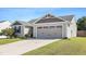 Lovely home featuring a large garage with decorative windows and a concrete driveway at 46 Bellini Dr, Angier, NC 27501