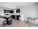 Open kitchen with stainless steel appliances, dark cabinetry, white countertops and seating at the island at 46 Bellini Dr, Angier, NC 27501