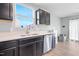Kitchen area featuring stainless steel dishwasher, dark cabinets, and a window over the sink at 46 Bellini Dr, Angier, NC 27501