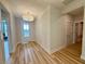 Bright hallway with hardwood floors and a centered light fixture that leads to the front door at 48 Firefly Ln, Fuquay Varina, NC 27526
