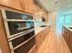 Modern kitchen featuring stainless steel appliances, white countertops, and hardwood floors at 48 Firefly Ln, Fuquay Varina, NC 27526