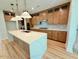 Modern kitchen featuring stainless steel appliances, an island with white countertops, and hardwood floors at 48 Firefly Ln, Fuquay Varina, NC 27526