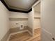 Bright laundry room featuring shelving and hookups, plus an adjoining walk-in closet at 48 Firefly Ln, Fuquay Varina, NC 27526
