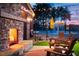 Cozy outdoor patio with a stone fireplace, lounge chairs, and pool view at 48 Firefly Ln, Fuquay Varina, NC 27526