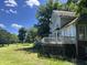 Large backyard with wooden deck, lawn, and mature trees at 4917 Harbour Towne Dr, Raleigh, NC 27604