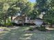 Charming single-Gathering home with an attached garage, surrounded by mature trees and landscaped flower beds at 4917 Harbour Towne Dr, Raleigh, NC 27604