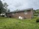 Brick ranch style house with white windows and a large backyard and central air conditioning at 503 Adams St, Henderson, NC 27536