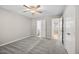 Neutral bedroom featuring soft carpet, ceiling fan, and access to a bathroom and hallway at 5082 Flint Ridge Pl, Raleigh, NC 27609