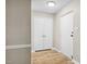 Bright entryway featuring neutral paint, wood floors, and convenient closet space at 5082 Flint Ridge Pl, Raleigh, NC 27609