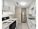 Efficient kitchen with stainless steel appliances, white cabinets, and ample counter space at 5082 Flint Ridge Pl, Raleigh, NC 27609