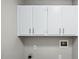 Laundry room with upper white cabinets at 5082 Flint Ridge Pl, Raleigh, NC 27609