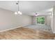 Spacious living room with carpet and sliding door access to a wooden porch and natural view at 5082 Flint Ridge Pl, Raleigh, NC 27609