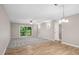 Spacious living room with carpet and sliding door access to a wooden porch at 5082 Flint Ridge Pl, Raleigh, NC 27609