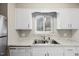 Bright kitchen featuring a stainless steel sink, updated countertops and a view from the window at 5082 Flint Ridge Pl, Raleigh, NC 27609