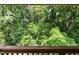 A view from a wooden deck looking out at lush greenery and trees at 5082 Flint Ridge Pl, Raleigh, NC 27609