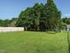 Spacious backyard with lush green grass, mature trees, and a privacy fence at 516 Yellow Berry, Wendell, NC 27591