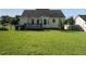 Well-maintained backyard with a deck, manicured lawn, and partial fencing at 516 Yellow Berry, Wendell, NC 27591