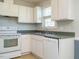 Kitchen featuring white appliances, white cabinets, and stainless steel sink at 516 Yellow Berry, Wendell, NC 27591