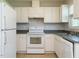 Kitchen featuring white appliances, white cabinets, and stainless steel sink at 516 Yellow Berry, Wendell, NC 27591