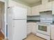 Kitchen featuring classic white appliances and white cabinets at 516 Yellow Berry, Wendell, NC 27591