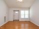 Cozy living room with hardwood floors, neutral walls, and a large window at 516 Yellow Berry, Wendell, NC 27591