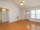 Hardwood living room featuring two doors, bright windows, and a ceiling fan at 516 Yellow Berry, Wendell, NC 27591
