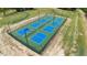 Aerial view of outdoor pickleball courts with nets and surrounding landscape at 516 Yellow Berry, Wendell, NC 27591