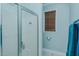 Bathroom featuring white walls, a glass shower, and a window with wooden blinds at 5307 Green Riley Rd, Rougemont, NC 27572