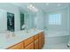 Bright bathroom with double vanity, large mirror, soaking tub, and walk-in closet at 5307 Green Riley Rd, Rougemont, NC 27572