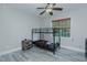 A bedroom with gray vinyl floors, a bunk bed, a ceiling fan, and a window at 5307 Green Riley Rd, Rougemont, NC 27572